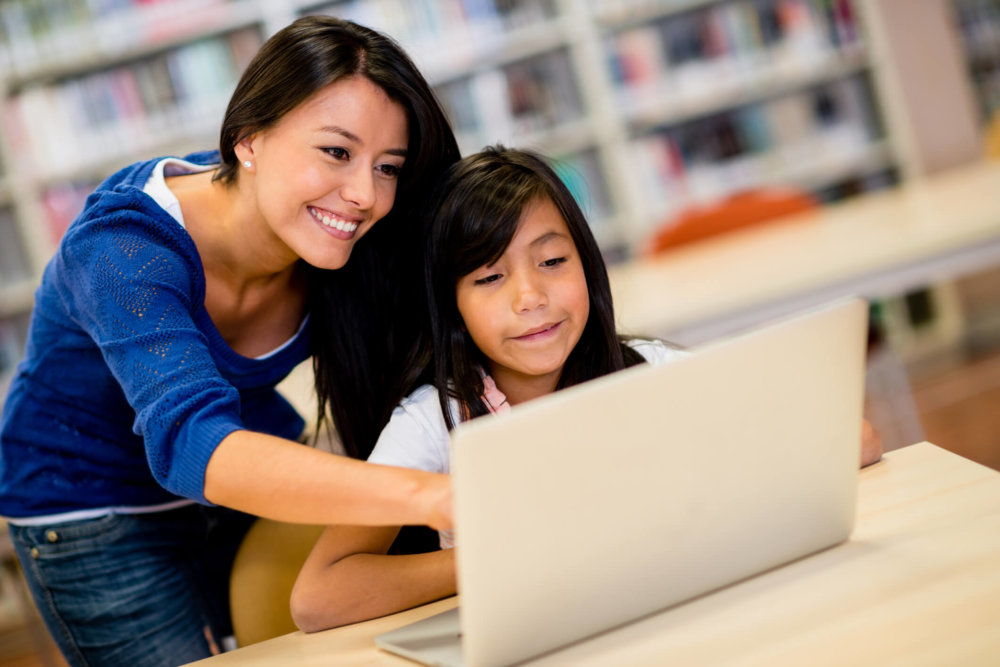 IT teacher helping young child with learning