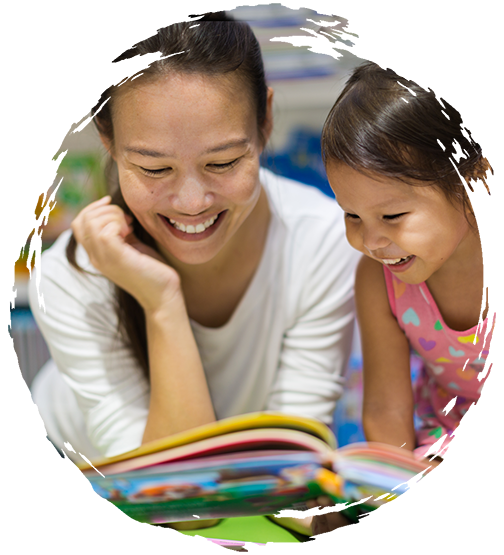 Teacher enjoying a book with a young child