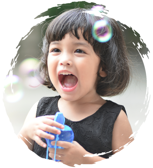 Young girl blowing bubbles and smiling