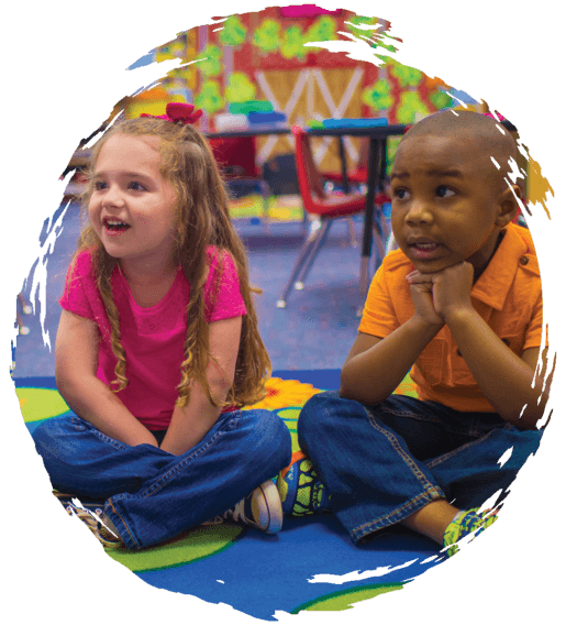 Pre-K children listening to story on mat